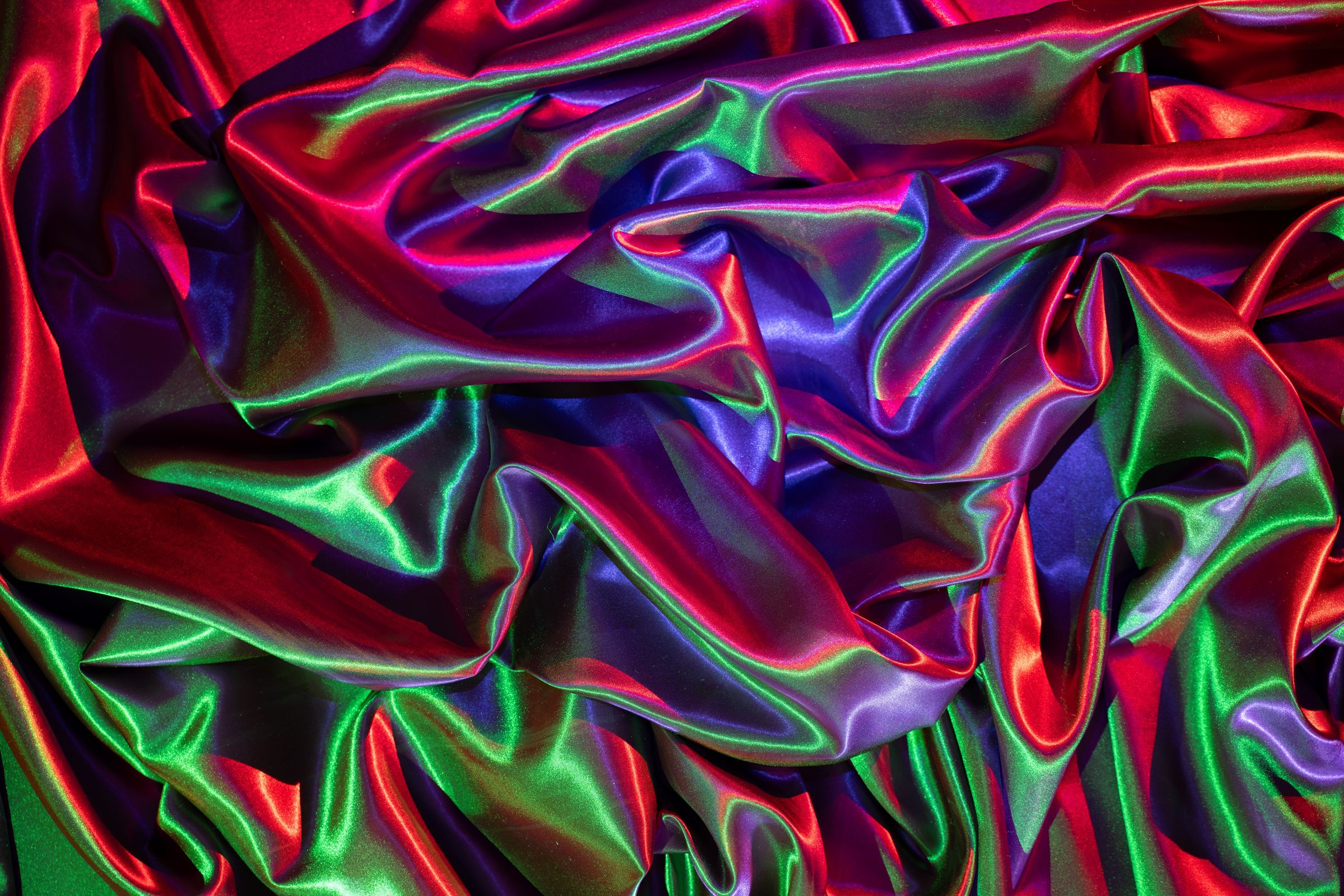 Red, green and blue satin folded into an abstract composition